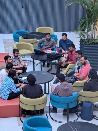 Attendees in a discussion circle on lounge chairs